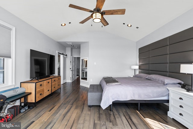 bedroom featuring lofted ceiling, a barn door, recessed lighting, wood finished floors, and baseboards