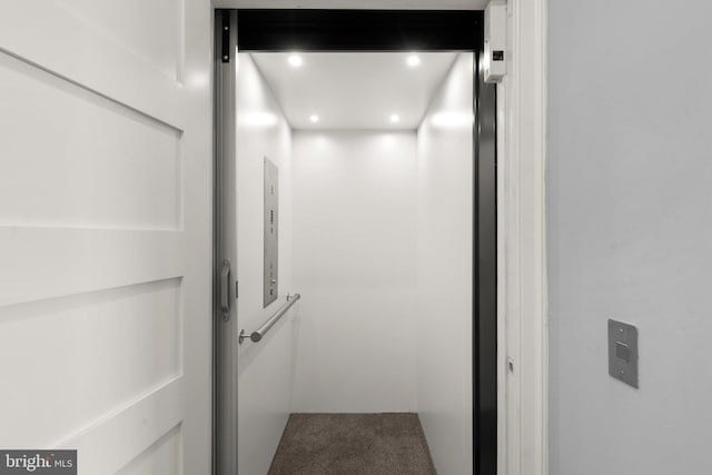 interior details with recessed lighting, elevator, and carpet flooring