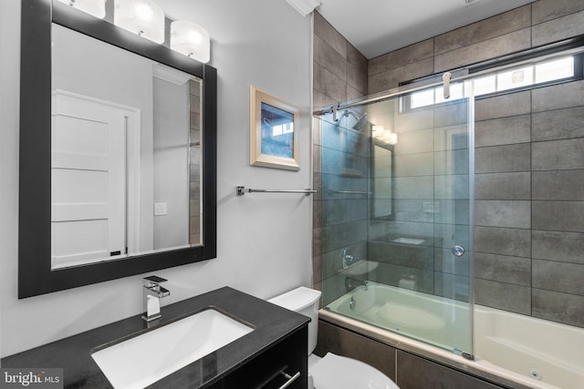 full bath featuring toilet, combined bath / shower with glass door, and vanity