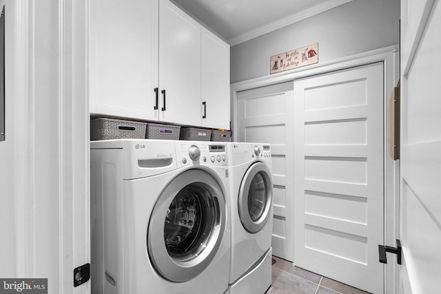 laundry room with ornamental molding, light tile patterned flooring, independent washer and dryer, and cabinet space