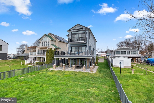 rear view of house featuring a patio area, a fenced backyard, a lawn, and a wooden deck