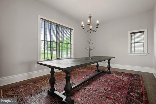 office area featuring a notable chandelier, wood finished floors, and baseboards