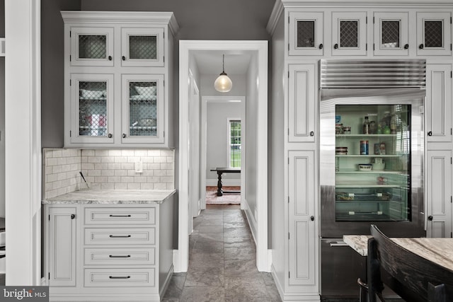 kitchen with glass insert cabinets, white cabinetry, and high end refrigerator