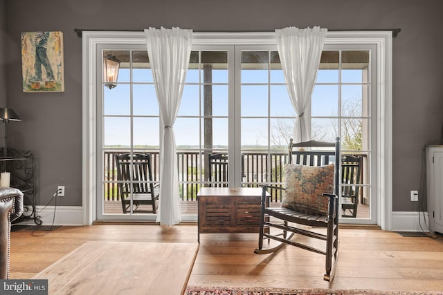 sitting room featuring light wood finished floors and baseboards