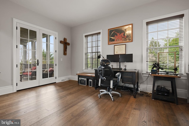 office space with baseboards, hardwood / wood-style floors, and french doors