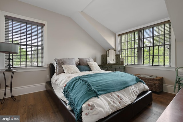 bedroom with dark wood-style floors, vaulted ceiling, and baseboards