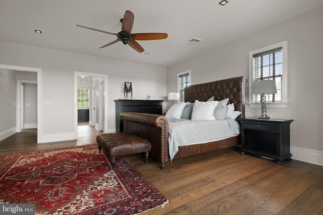 bedroom featuring multiple windows, dark wood-style flooring, visible vents, and baseboards