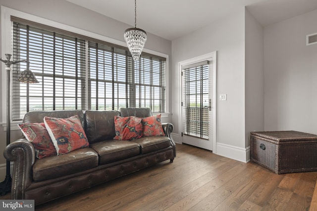 living room with baseboards, visible vents, dark wood finished floors, and a wealth of natural light