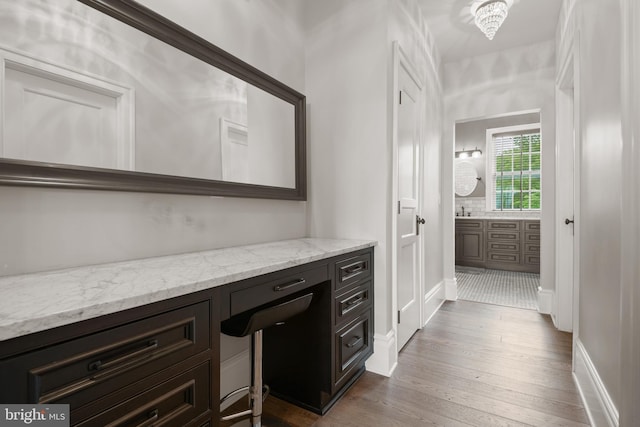 bathroom with vanity, baseboards, and wood finished floors