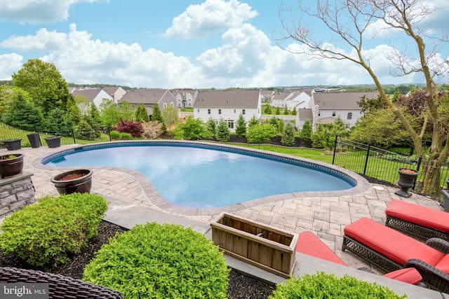 view of pool featuring a fenced in pool, a residential view, and fence