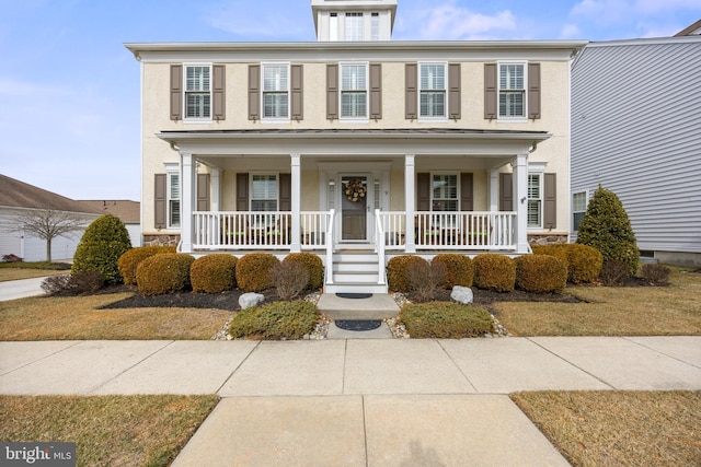 view of front of home featuring a porch and stucco siding