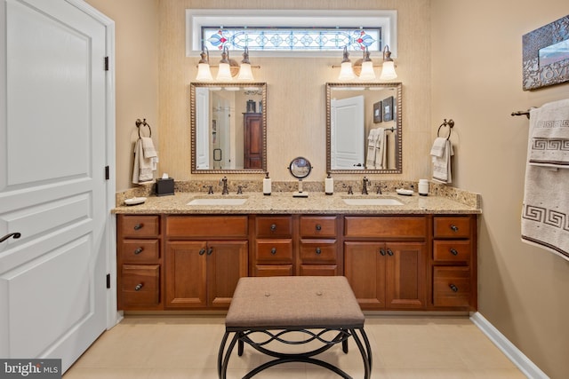 bathroom featuring double vanity, a sink, and tile patterned floors