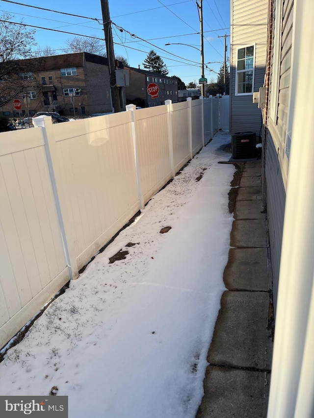 view of yard featuring central AC unit and fence