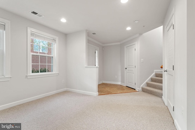 spare room with recessed lighting, light carpet, visible vents, and baseboards