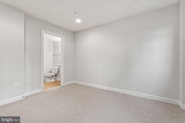 empty room featuring baseboards, recessed lighting, and light colored carpet