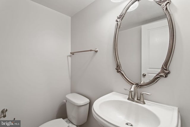 bathroom featuring toilet and a sink