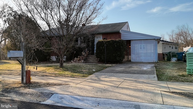 view of front facade featuring brick siding and driveway