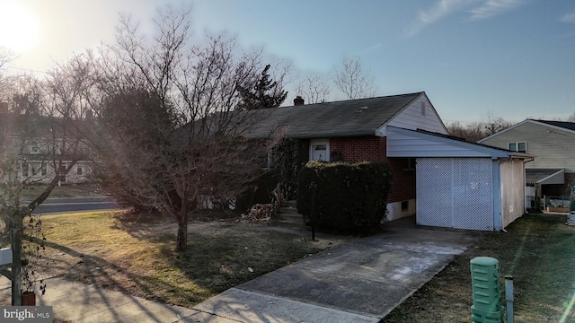 exterior space with a chimney and a front yard