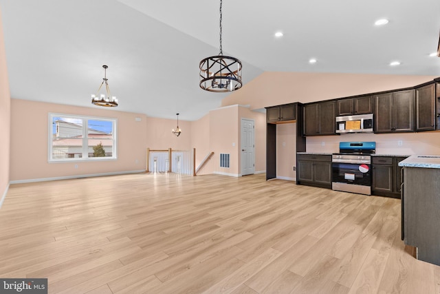 kitchen featuring a notable chandelier, light countertops, appliances with stainless steel finishes, dark brown cabinetry, and light wood-type flooring