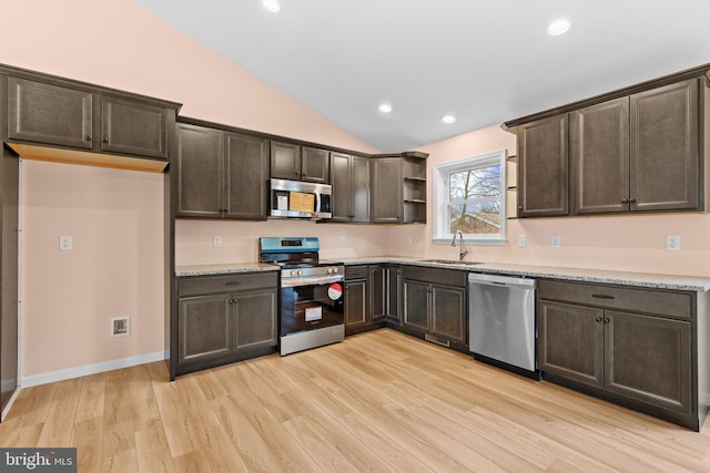 kitchen with dark brown cabinetry, stainless steel appliances, light wood-style floors, open shelves, and a sink