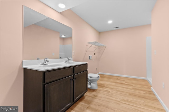 full bath featuring wood finished floors, a sink, and baseboards