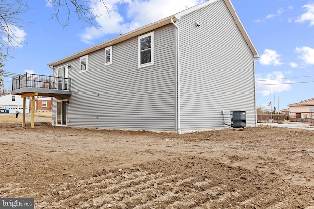 view of side of home with central AC and a wooden deck