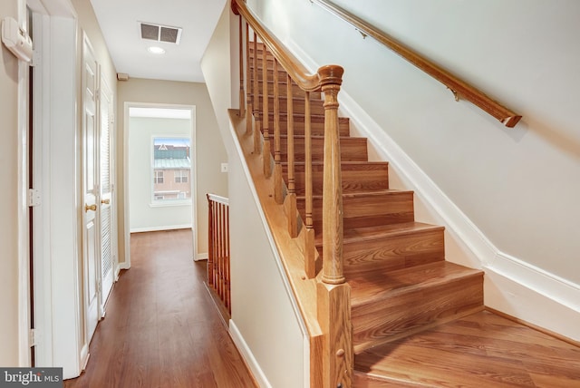 stairs featuring recessed lighting, visible vents, baseboards, and wood finished floors