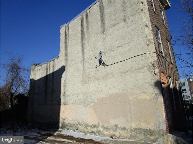 view of side of property featuring stucco siding