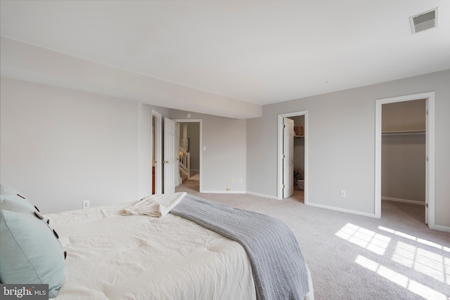 7014 Ellingham Cir Unit F, Alexandria, VA 22315 - carpeted bedroom featuring a walk in closet and baseboards
