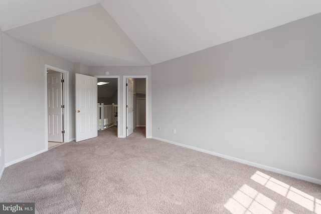 7014 Ellingham Cir Unit F, Alexandria, VA 22315 - unfurnished bedroom featuring carpet, lofted ceiling, a spacious closet, and baseboards