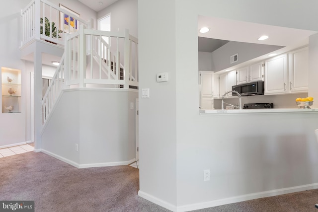 7014 Ellingham Cir Unit F, Alexandria, VA 22315 - kitchen featuring carpet floors, white cabinets, and baseboards