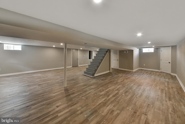 below grade area featuring recessed lighting, stairway, baseboards, and wood finished floors