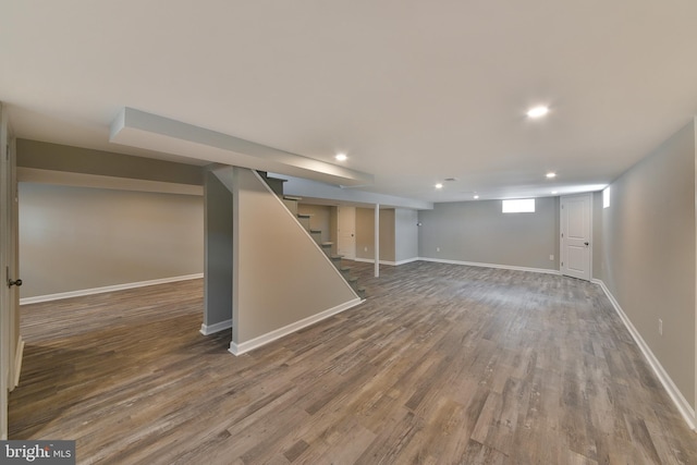 basement featuring stairway, recessed lighting, wood finished floors, and baseboards