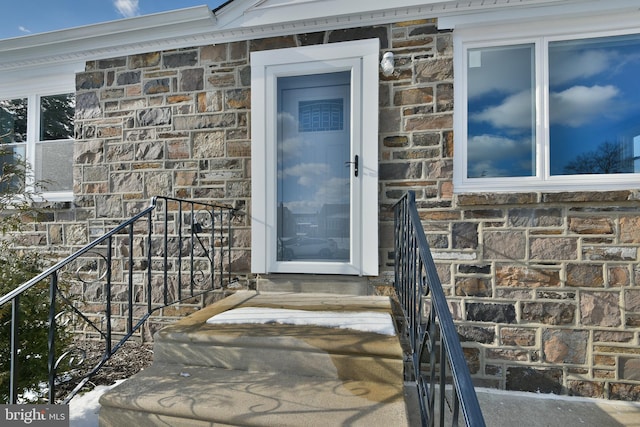 property entrance featuring stone siding