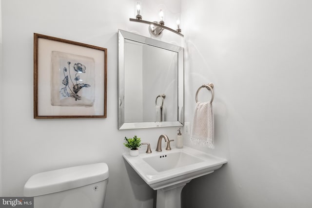 bathroom with toilet and a sink