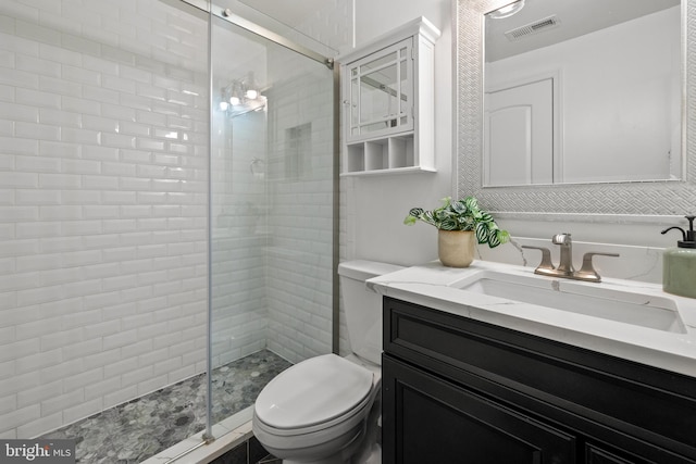 full bath with visible vents, a shower stall, toilet, and vanity