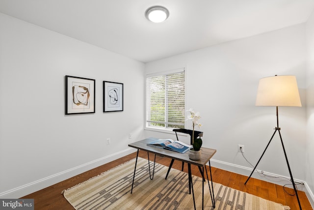 office space with baseboards and wood finished floors