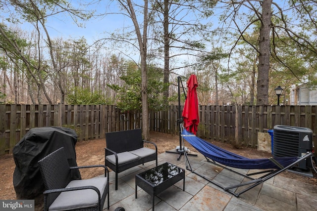 view of patio / terrace featuring cooling unit and a fenced backyard