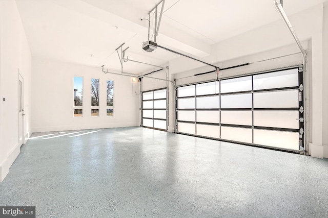 garage featuring a garage door opener and baseboards