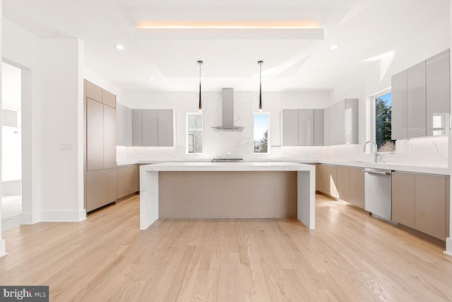 kitchen featuring wall chimney exhaust hood, appliances with stainless steel finishes, modern cabinets, and gray cabinetry