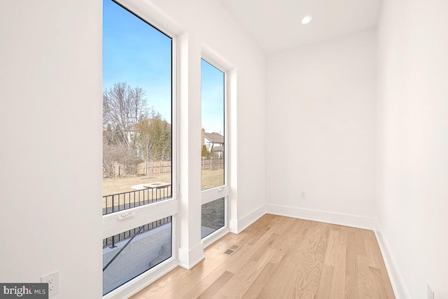 doorway with recessed lighting, light wood-type flooring, visible vents, and baseboards