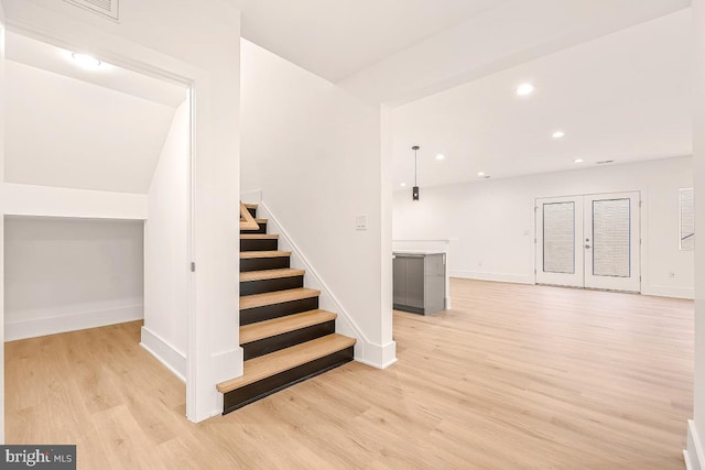 stairway featuring recessed lighting, baseboards, and wood finished floors