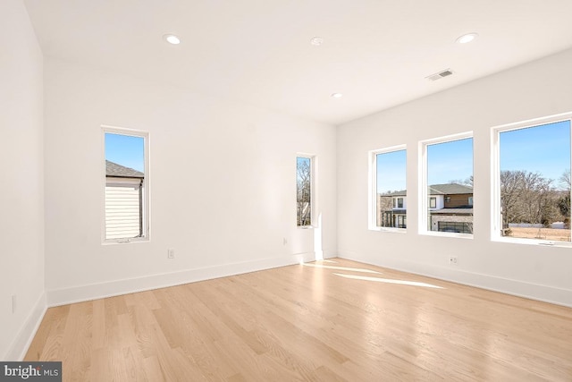 spare room featuring baseboards, recessed lighting, visible vents, and light wood-style floors