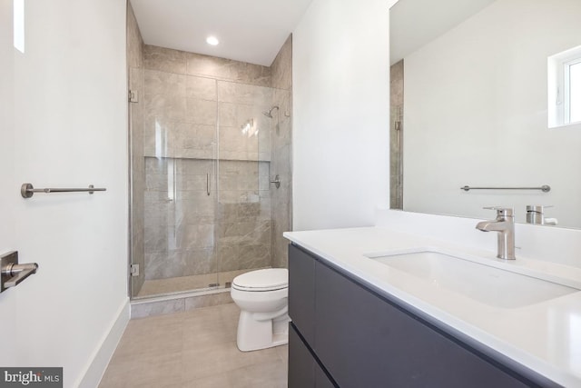 bathroom with recessed lighting, toilet, a shower stall, vanity, and baseboards