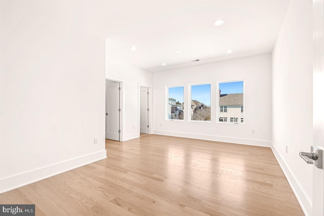 empty room with visible vents, recessed lighting, light wood-style flooring, and baseboards