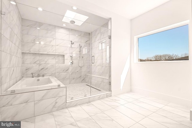 bathroom with a skylight, a stall shower, baseboards, a garden tub, and recessed lighting