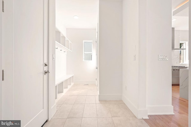 mudroom featuring light tile patterned floors and baseboards