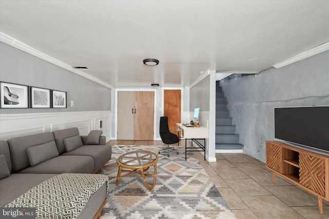 living room featuring crown molding, visible vents, a decorative wall, light tile patterned flooring, and stairs