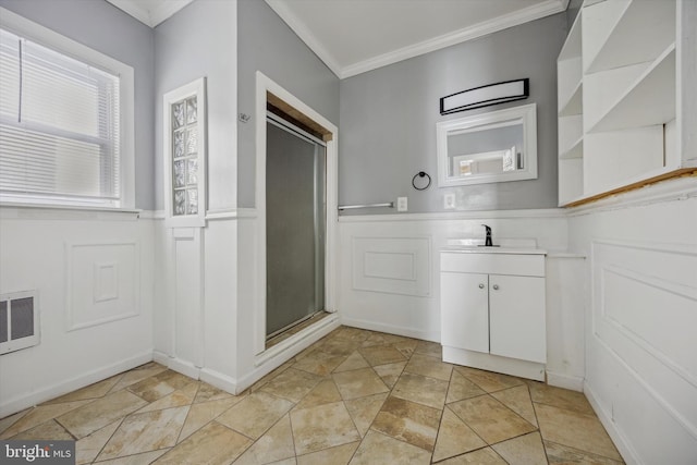 bathroom with crown molding, visible vents, wainscoting, a shower stall, and vanity