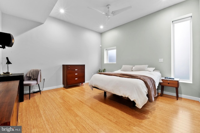 bedroom featuring light wood-type flooring, ceiling fan, baseboards, and recessed lighting